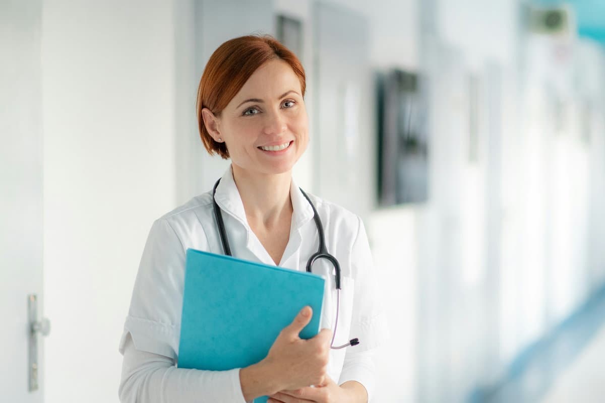 A clinician completing a report on a clipboard.