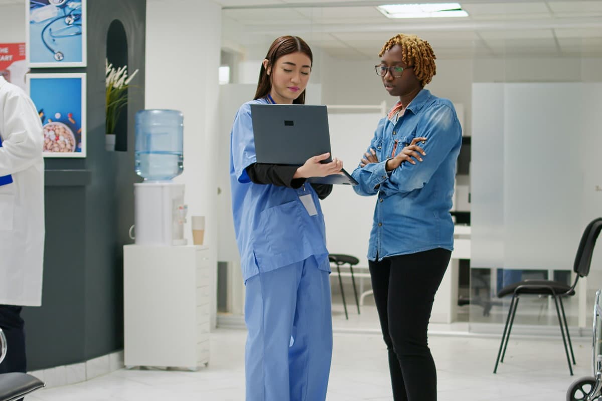 A physician and a nurse reviewing a chart together.